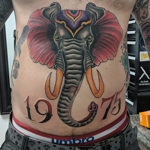 Explore cupid tattoo ideas, creative tattoo ideas in New Bern, available at Ol Skool Tattoos