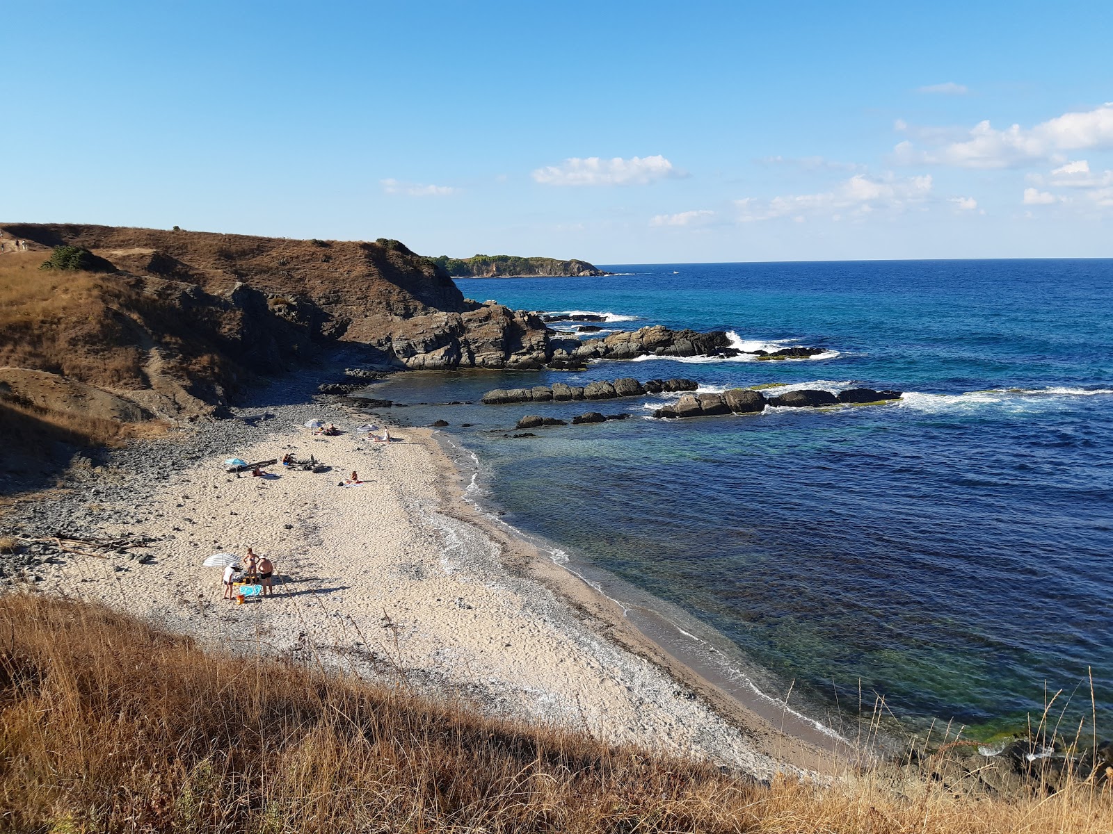 Fotografie cu Lipite beach cu o suprafață de nisip beige și pietre