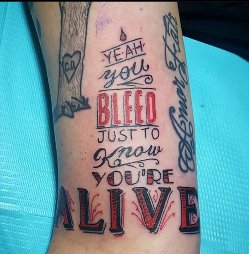 Explore fishing hook tattoo ideas, creative tattoo ideas in Traverse City, available at Black Candle Tattoo Co.