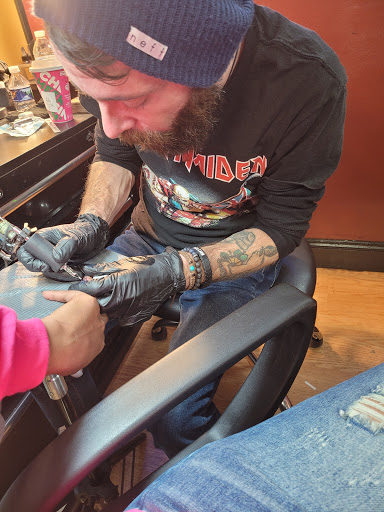 Explore lung cancer ribbon tattoo ideas, creative tattoo ideas in Cheltenham, available at Louder Than Bombs Tattoo