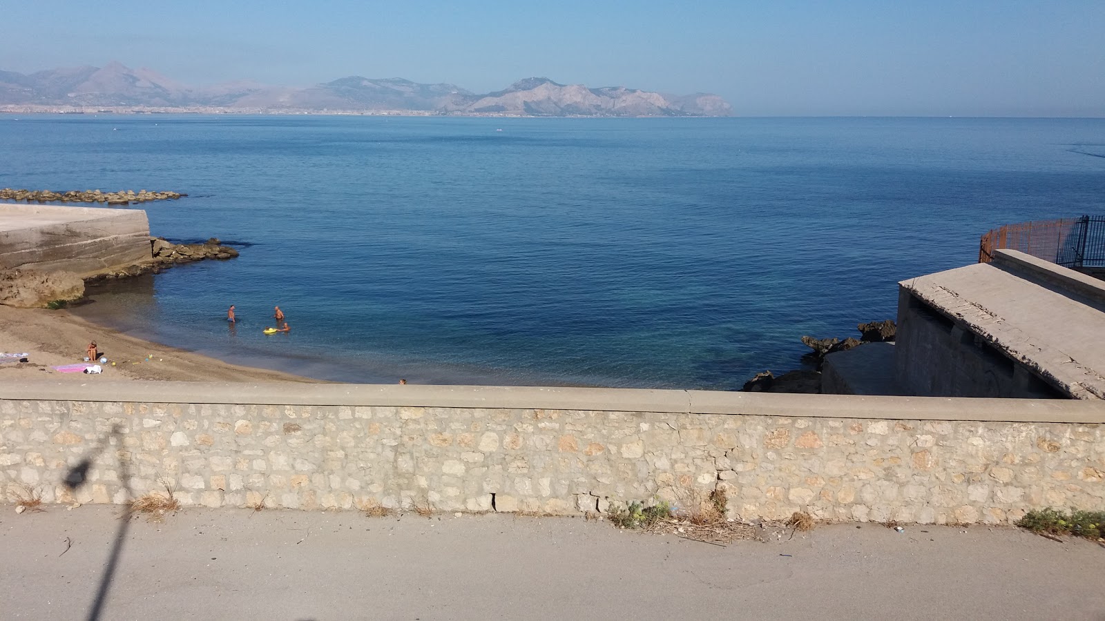 Foto von Aspra pier beach mit feiner grauer kies Oberfläche