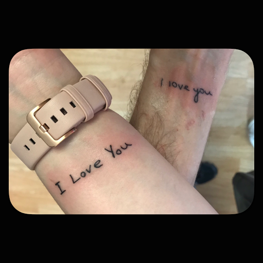 Find boyfriend name tattoo under breast ideas for your next unique tattoo in Vermillion at IKTOMI-INK Tattoo Experience