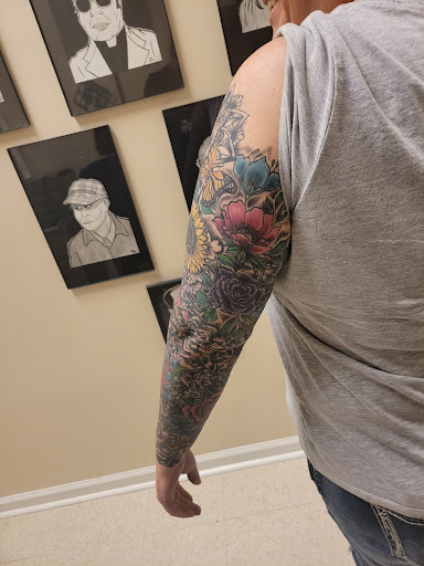Explore flower tattoo sleeve ideas, creative tattoo ideas in Ozark, available at Tooth & Nail Tattoo & Piercing