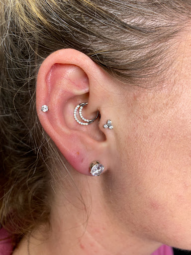 Explore easy hand tattoo ideas, creative tattoo ideas in Orange, available at Symbiosis Body Piercing