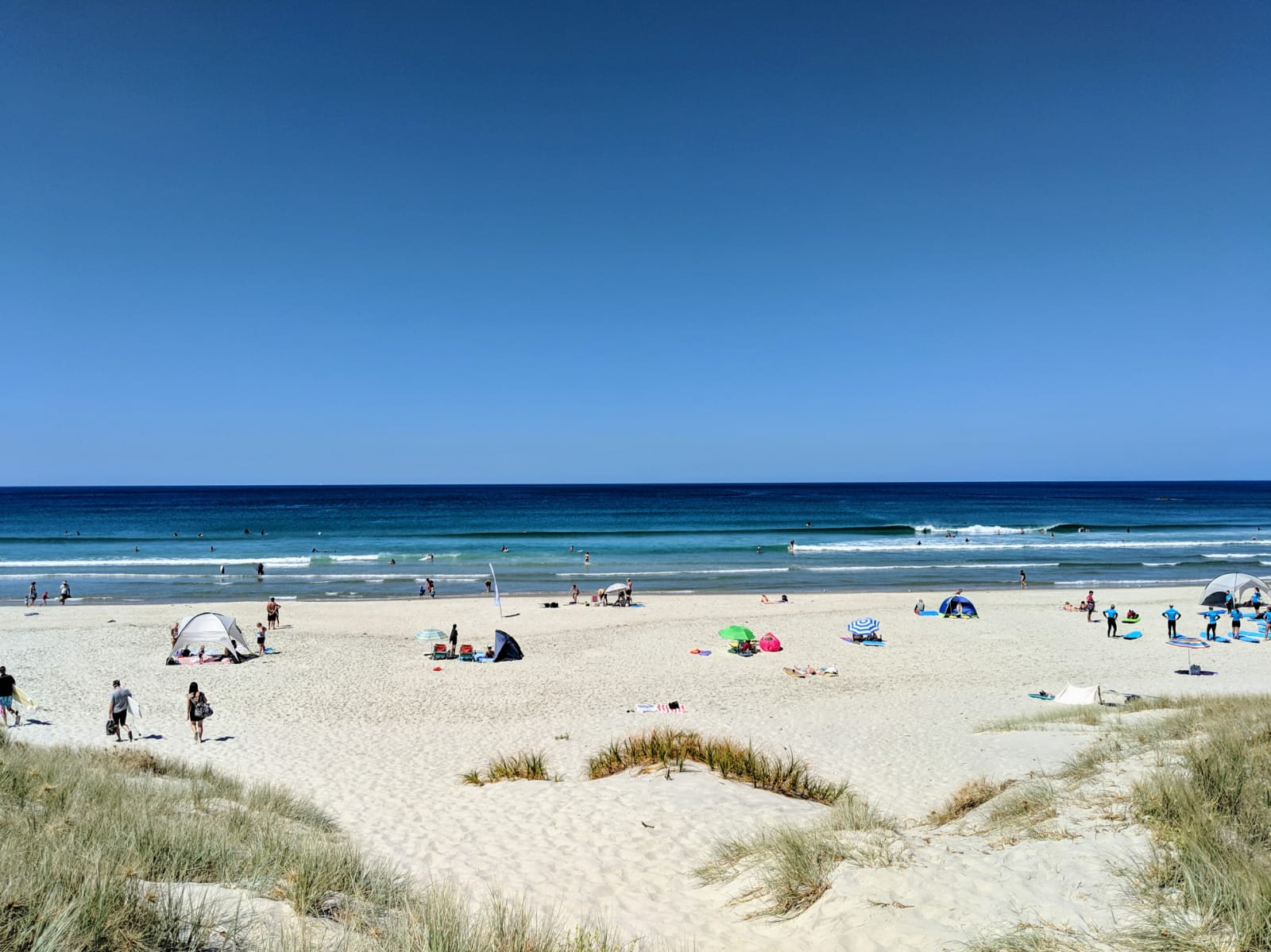 Fotografija Te Arai Beach z svetel pesek površino