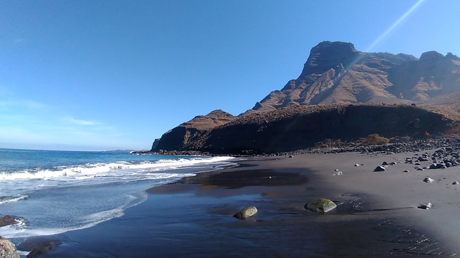 Fotografija Playa Del Risco z harmaa hiekka ja kivi površino