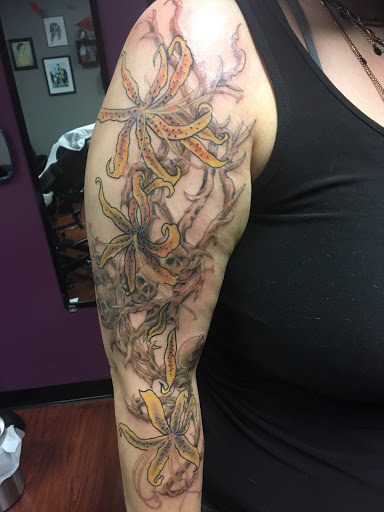 Explore cover up tattoo ideas for upper arm, creative tattoo ideas in Coldwater, available at Relevant Tattoo and Piercing