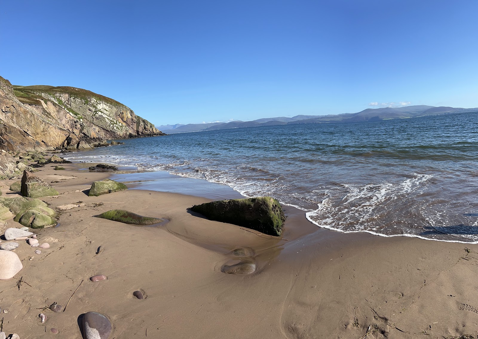 Photo of Minard Beach surrounded by mountains