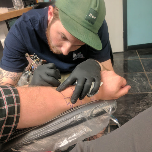 Explore purple flower tattoo ideas, creative tattoo ideas in Longview, available at Fugis Tattoo Shop