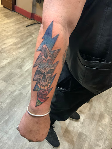 Explore cross tattoo ideas for females, creative tattoo ideas in Albany, available at The Curly Wolf Tattoo Club