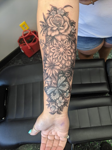 Explore cross tattoo sleeve ideas, creative tattoo ideas in Slippery Rock, available at Dinky Dachshund Tattoo Parlor