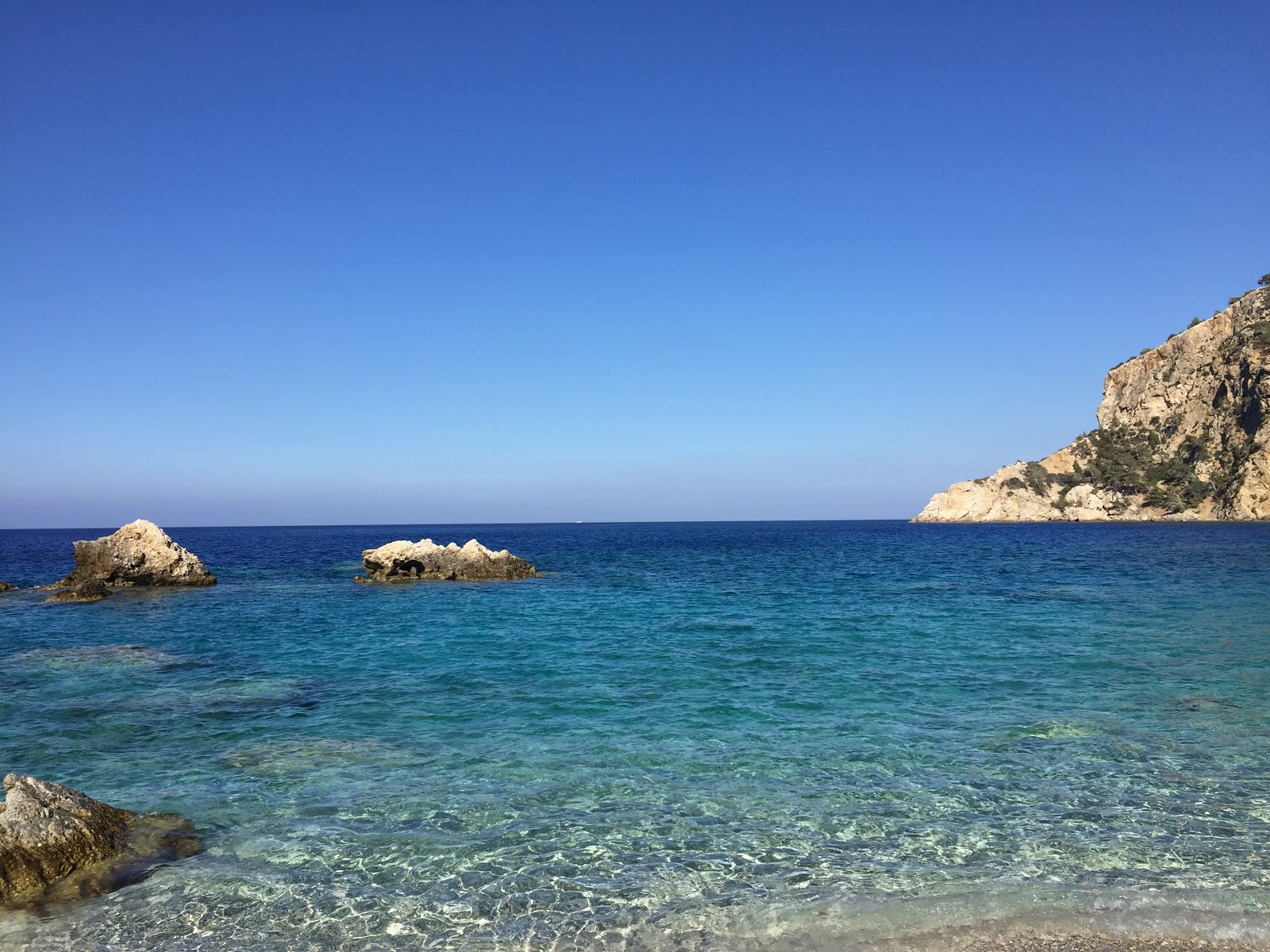 Photo of Apella beach with turquoise pure water surface