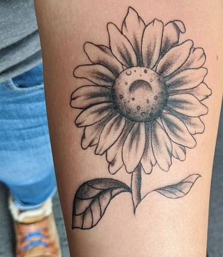 Explore sunflower thigh tattoo ideas, creative tattoo ideas in Lawrence, available at Standard Electric Tattooing