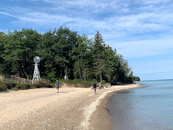Photo of 40 Mile Point Lighthouse with turquoise pure water surface