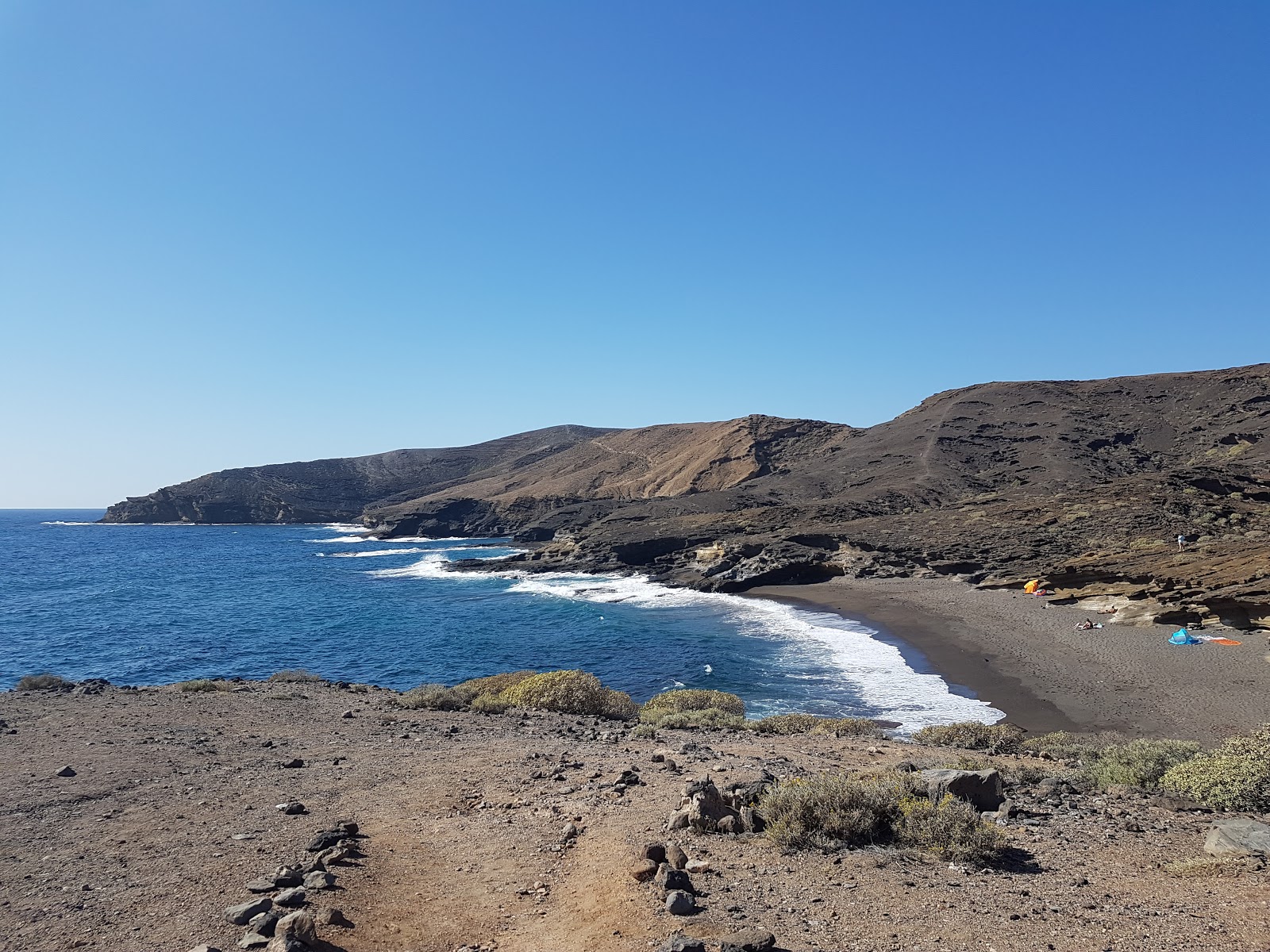 Foto av Playa Escondida med brunsand yta