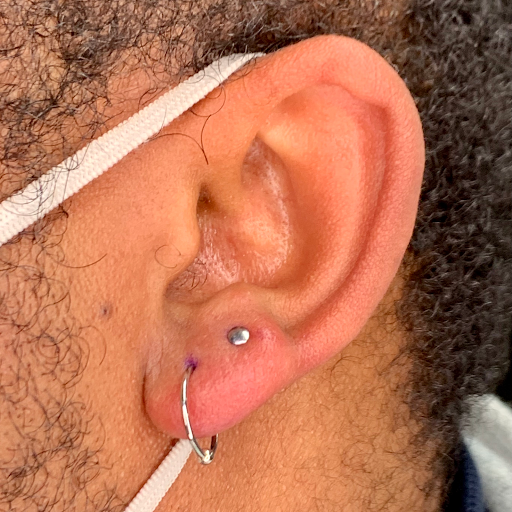 Explore red hand tattoo ideas, creative tattoo ideas in Powell, available at Elysium Body Enhancements