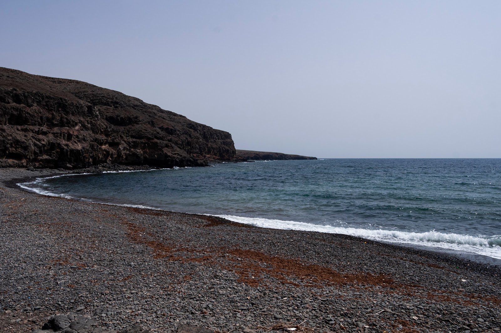 Foto von Playa de Leandro mit grauer sand & felsen Oberfläche