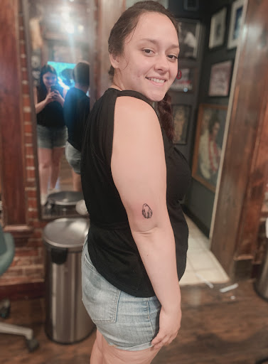 Explore book dragon tattoo ideas, creative tattoo ideas in Geneva, available at The Lonesome Rose Tattoo Parlor