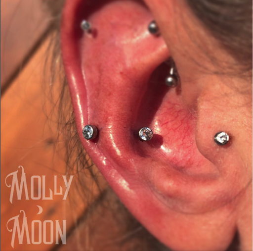 Explore black tattoo ideas for women, creative tattoo ideas in Oshkosh, available at Piercings by Molly Moon at 920 Tattoo and Piercing