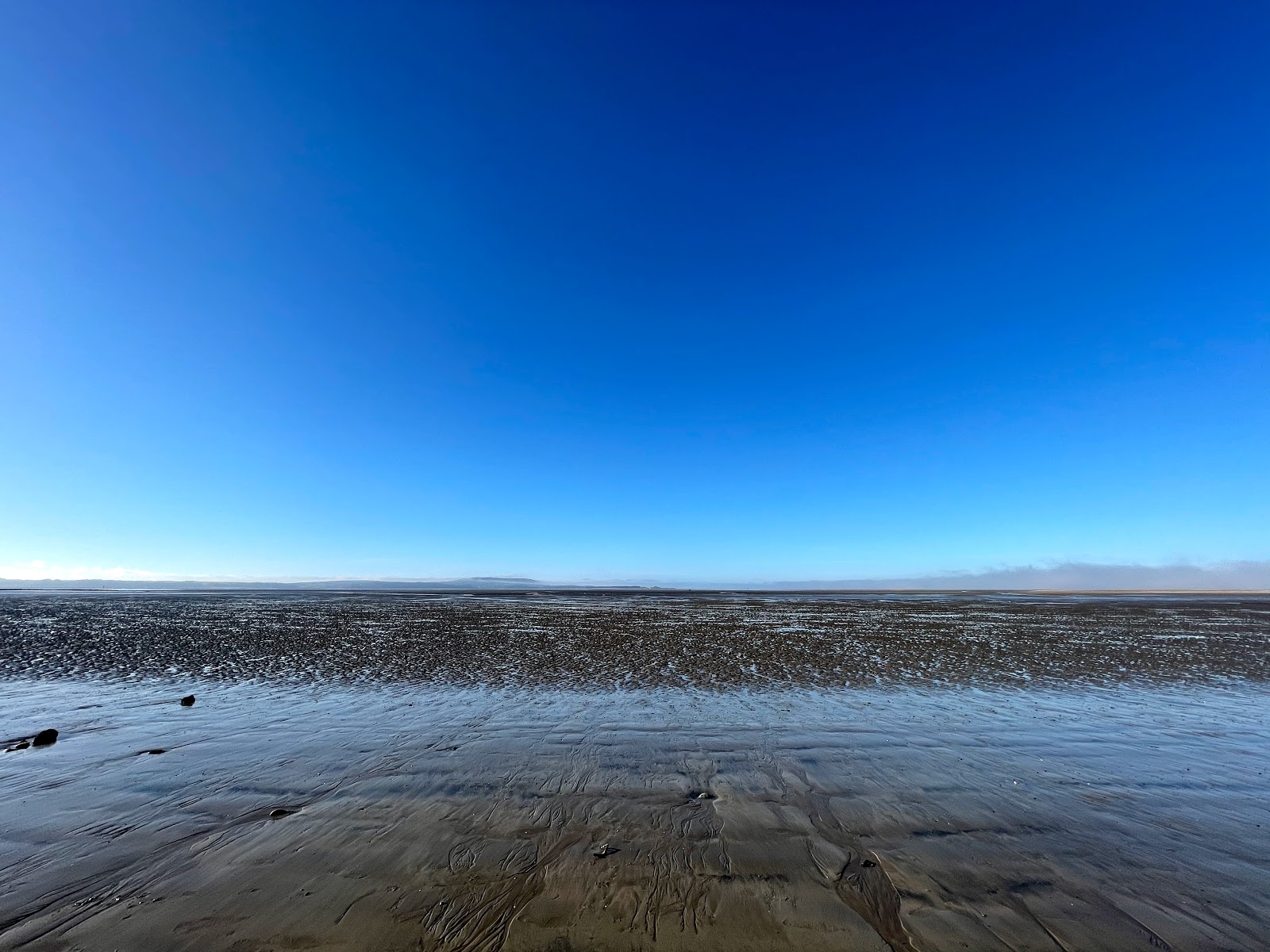 Foto av Llanelli strand med turkosa vatten yta