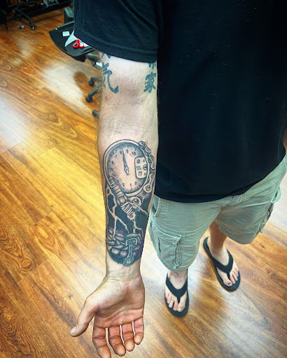 Explore black and grey sleeve tattoo ideas, creative tattoo ideas in Cocoa, available at Rorschach Tattoo Shop and Piercing Studio