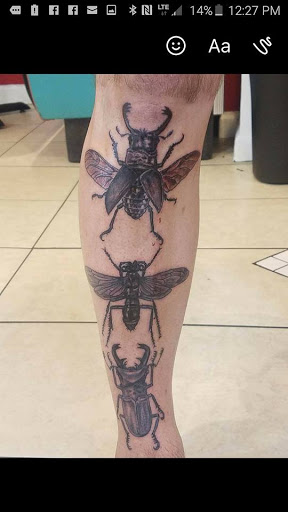 Explore calf tattoo ideas for guys, creative tattoo ideas in Columbus, available at Infamous Ink Tattoos and Piercings