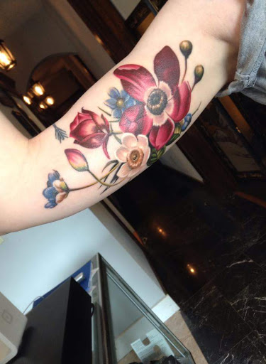 Explore women's arm sleeve tattoo ideas, creative tattoo ideas in Bridgeport, available at Pike Street Studios Tattoo and Body Piercing