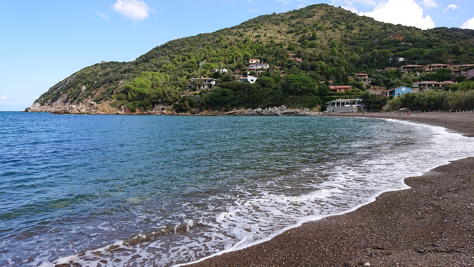 Photo of Nisporto Beach with brown fine pebble surface