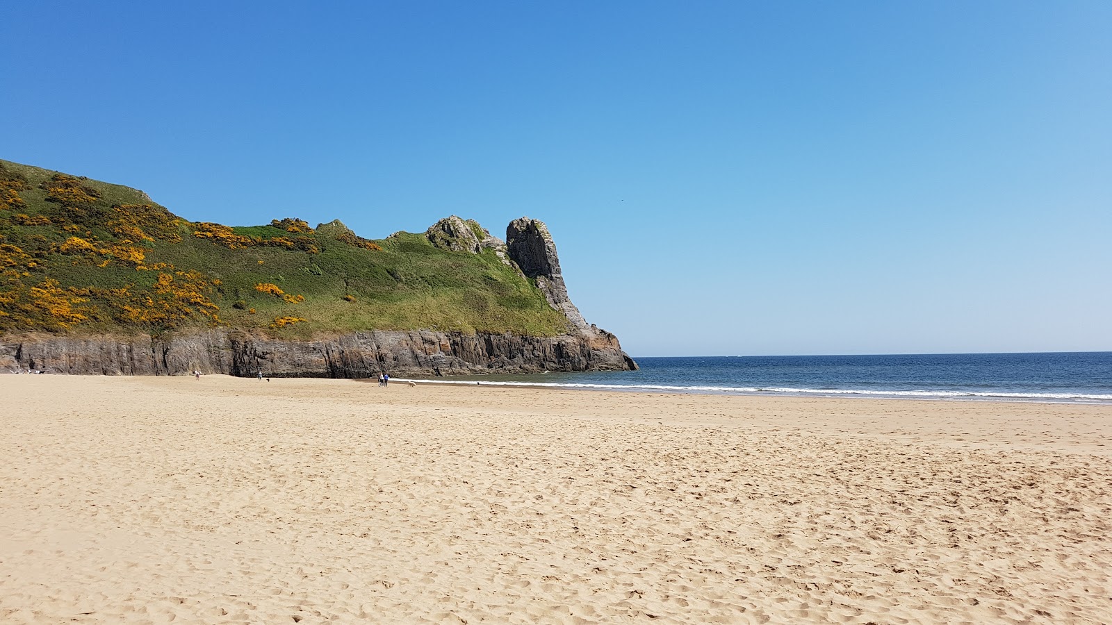 Photo of Oxwich Bay beach with bright fine sand surface