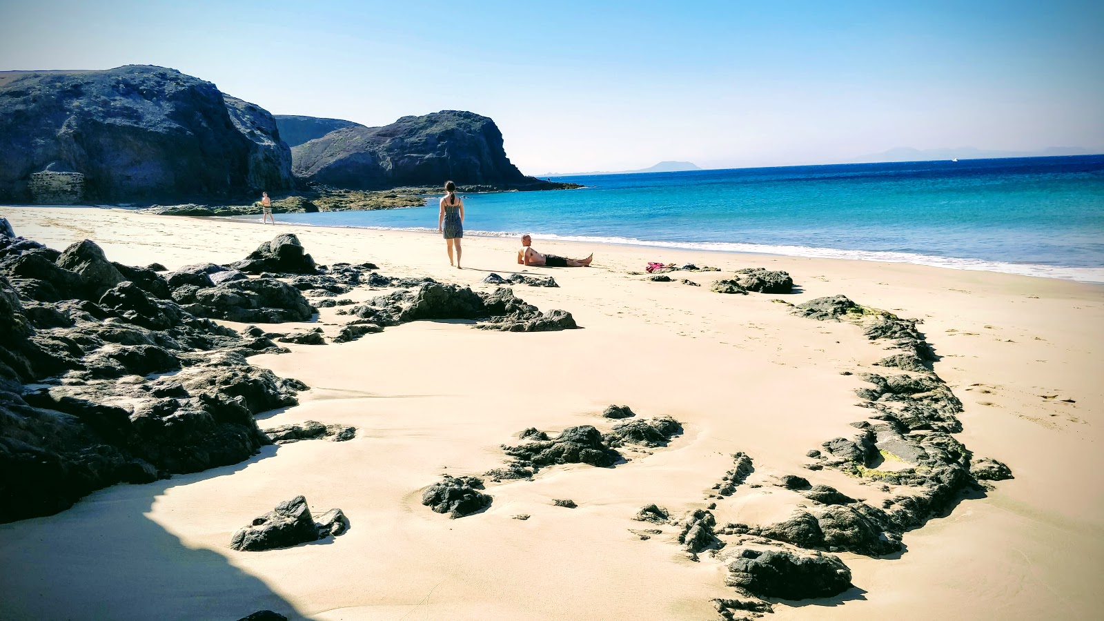 Valokuva Playa de la Ceraista. ympäröity vuorilla