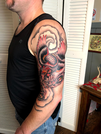 Explore black and grey realism tattoo ideas, creative tattoo ideas in Kingsford, available at Deft Tattoo Studio