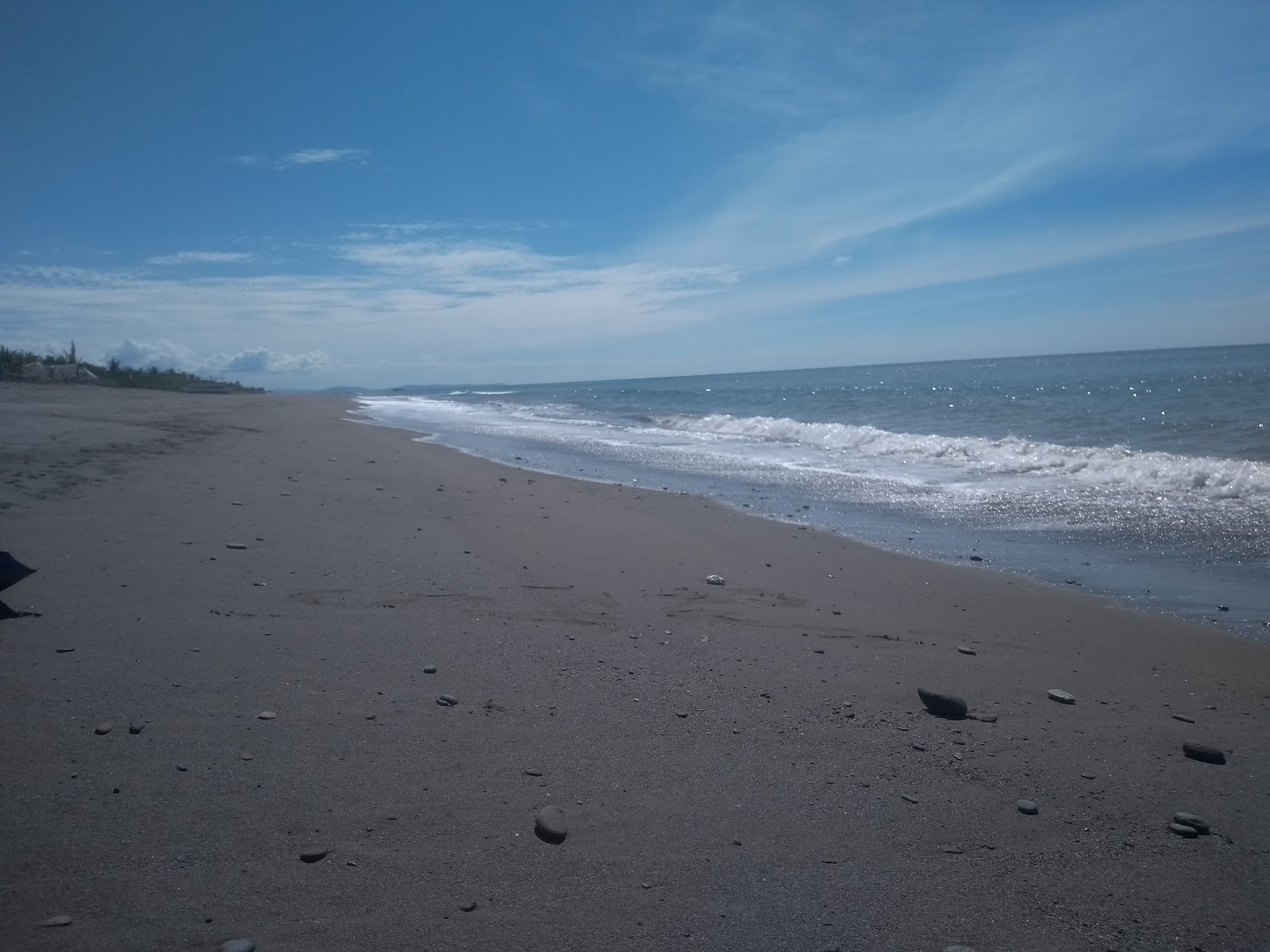 Foto di Mulawin Beach con una superficie del sabbia grigia