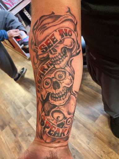 Explore cross hand tattoo ideas, creative tattoo ideas in Pikeville, available at The Carbon Canary Tattoo Studio
