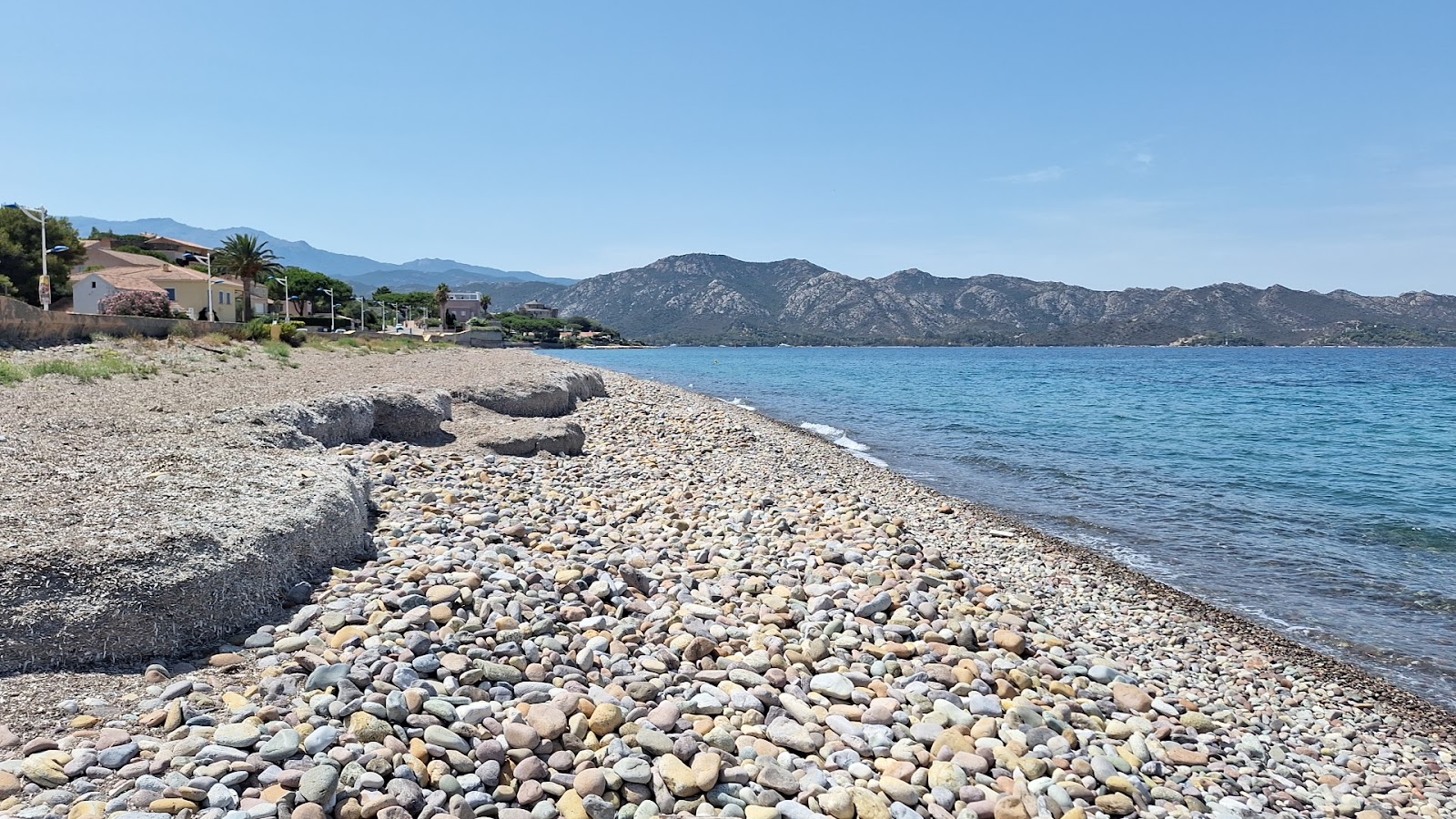 Photo of Plage de l'Ospedale with gray pebble surface