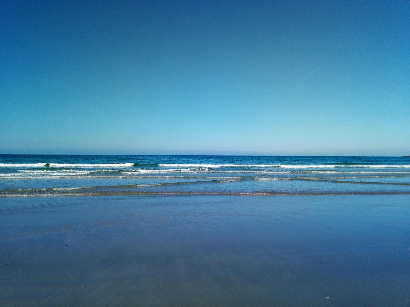 Valokuva Purakaunui Beachista. pinnalla turkoosi vesi:n kanssa