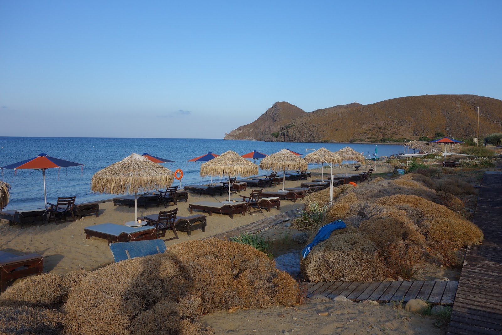 Photo of Ag.Ioannis beach backed by cliffs