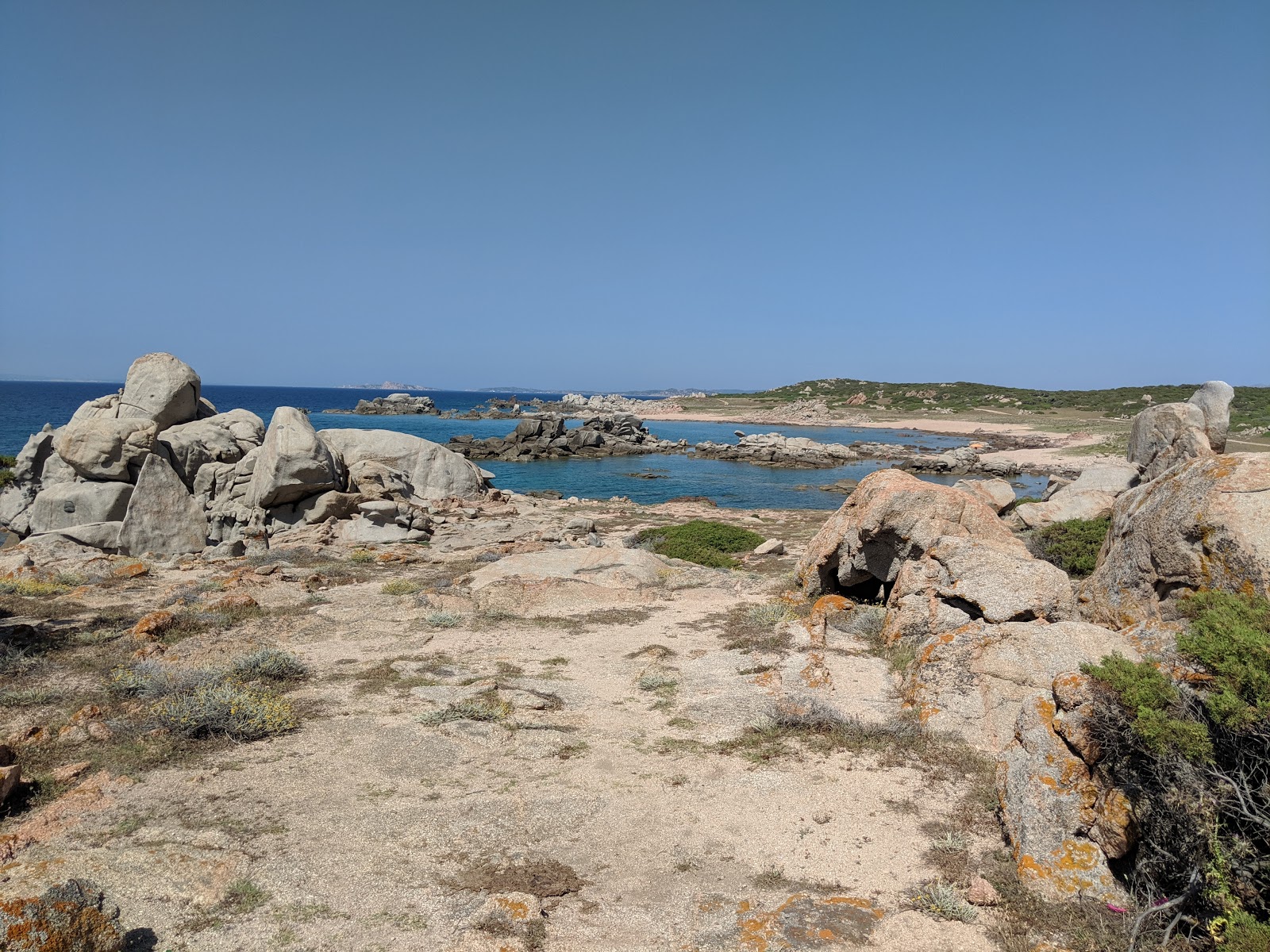 Photo of Li Cossi beach with turquoise pure water surface