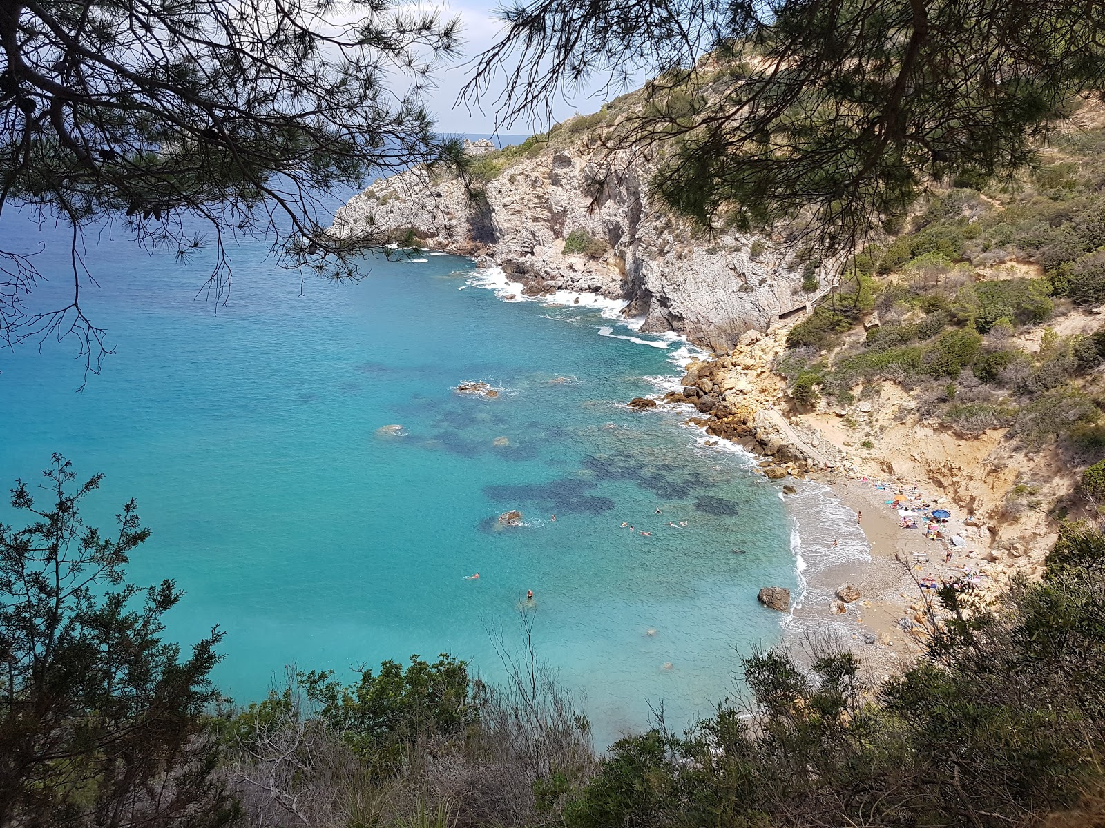 Photo of Cala del Gesso with blue pure water surface