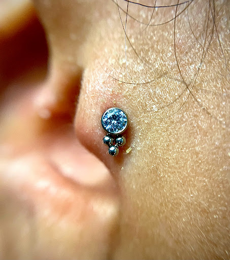 Explore one word tattoo ideas, creative tattoo ideas in Orange, available at Symbiosis Body Piercing