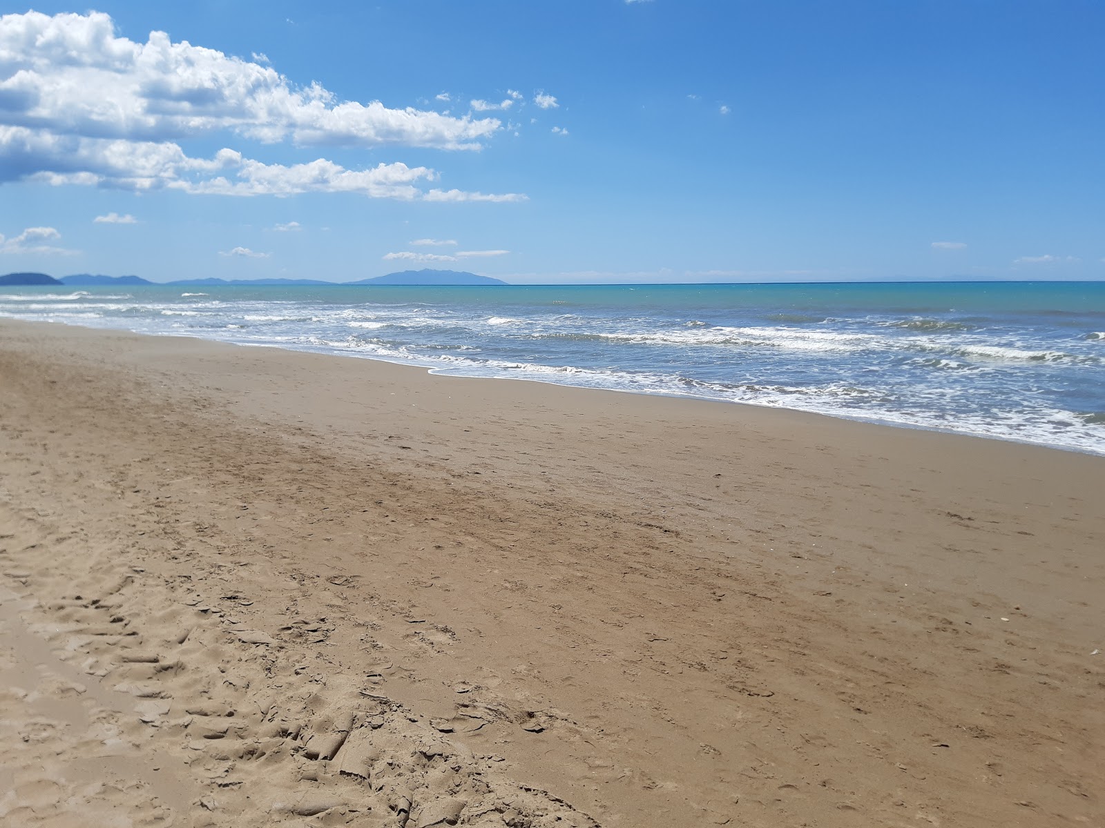 Photo of San Vincenzo beach with long straight shore