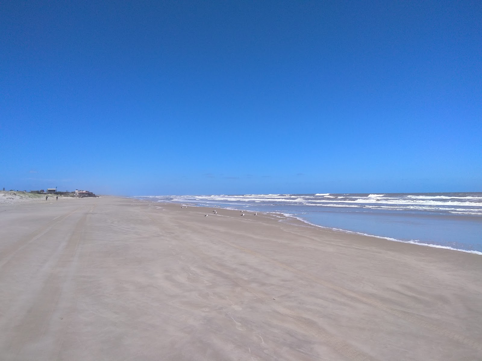Foto di Spiaggia delle Meraviglie con una superficie del sabbia beige