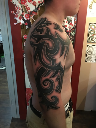 Explore female dragon tattoo ideas, creative tattoo ideas in Kingsford, available at Deft Tattoo Studio