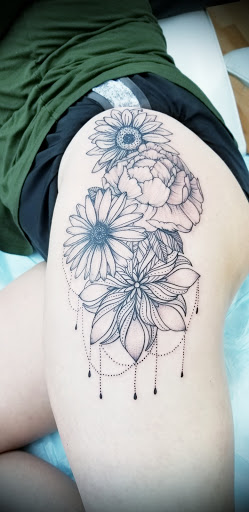 Explore cover up tattoo ideas for lower back, creative tattoo ideas in Benton, available at Spectrum Tattoo