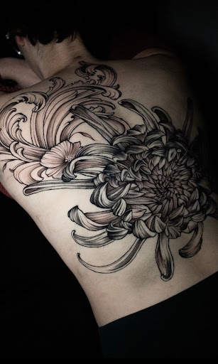 Explore red hand tattoo ideas, creative tattoo ideas in Arlington, available at Benchmark Tattoos