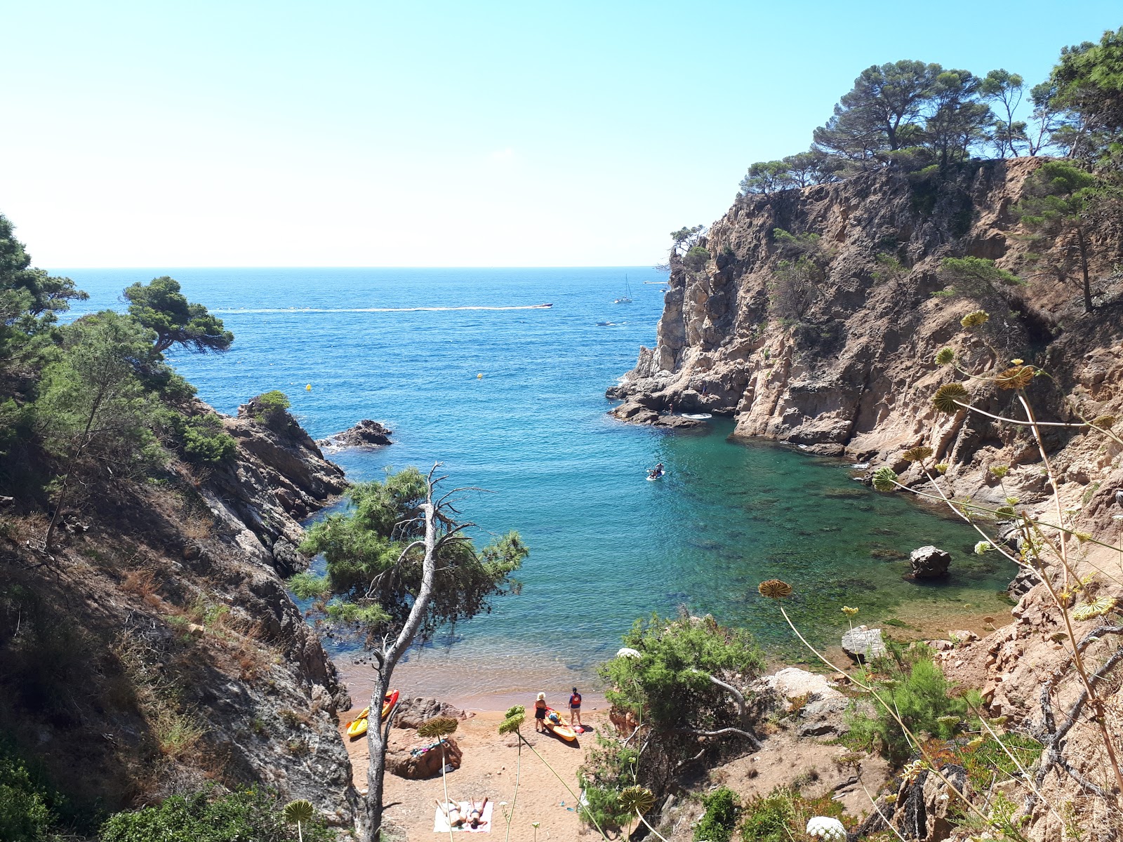 Photo of Cala Corbs with bright sand & rocks surface
