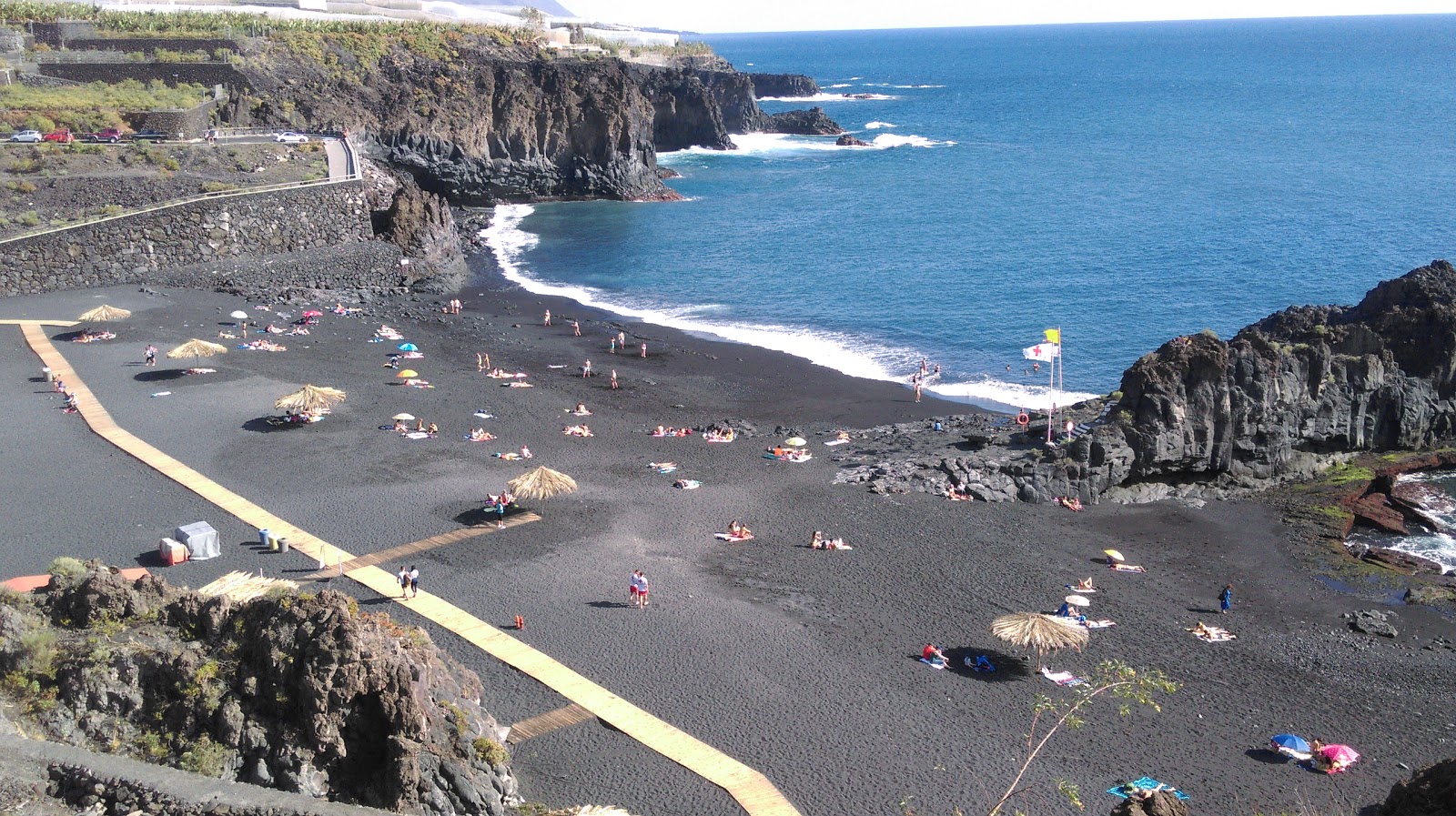 Photo of Playa de Charco Verde with black sand surface