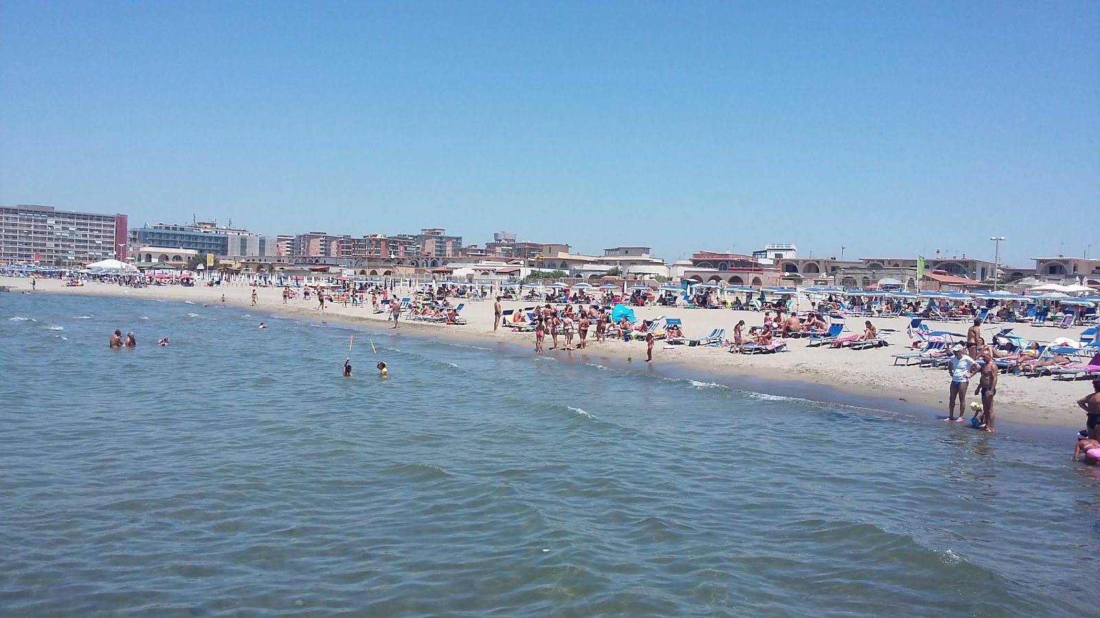 Fotografie cu Blue Sky beach cu o suprafață de nisip strălucitor