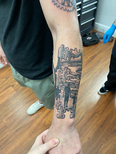 Explore hand tattoo ideas man, creative tattoo ideas in Cocoa, available at Rorschach Tattoo Shop and Piercing Studio