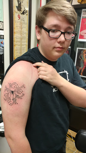 Explore mens space tattoo ideas, creative tattoo ideas in Pelham, available at Tattoo Expression