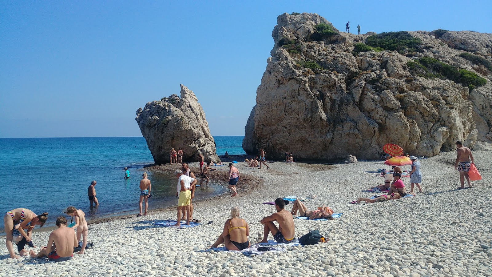 Photo of Aphrodite's rock beach surrounded by mountains